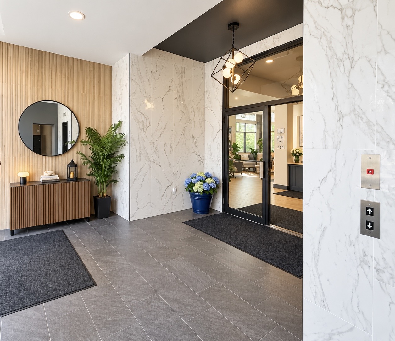 Building main lobby with marble-patterned walls, wood detailing, and elevator controls